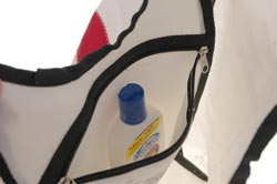 There is one zippered pouch inside of the recycled Sailcloth Beach Bag.