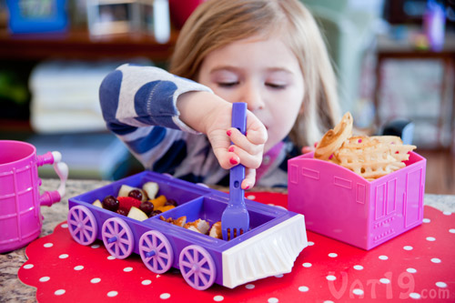Child eating from the Chew-Chew Train dinner set.