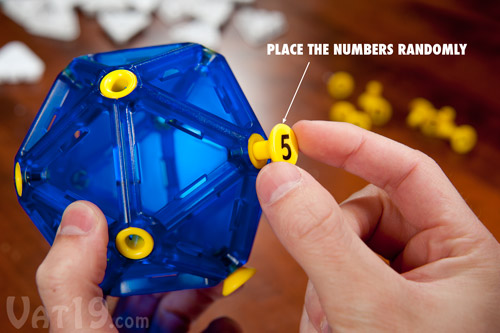 To start a game of IcoSoKu, place the number buttons randomly on the Icosahedron puzzle ball.