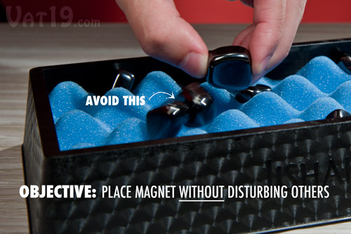 The objective of Jishaku is to place your magnet onto the board without disturbing any of the other magnets.