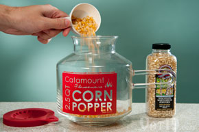 Pour the kernels into the glass microwave popcorn popper.