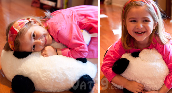 Squishables stuffed animal Panda being hugged by a little girl.