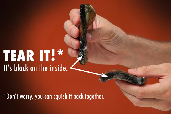 Tear Super Illusions Putty to reveal a solid black inside.