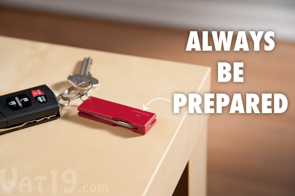 Compact keychain Swiss Army Knife resting on a table.