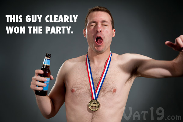 Half-naked man displaying why he won the Gold Medal Bottle Opener.