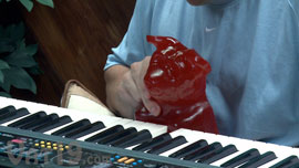 World's Largest Gummy Bear learning to play the piano.